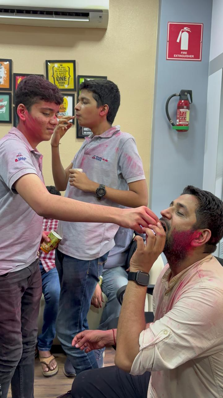 Students applying tilak to mentor on Holi
